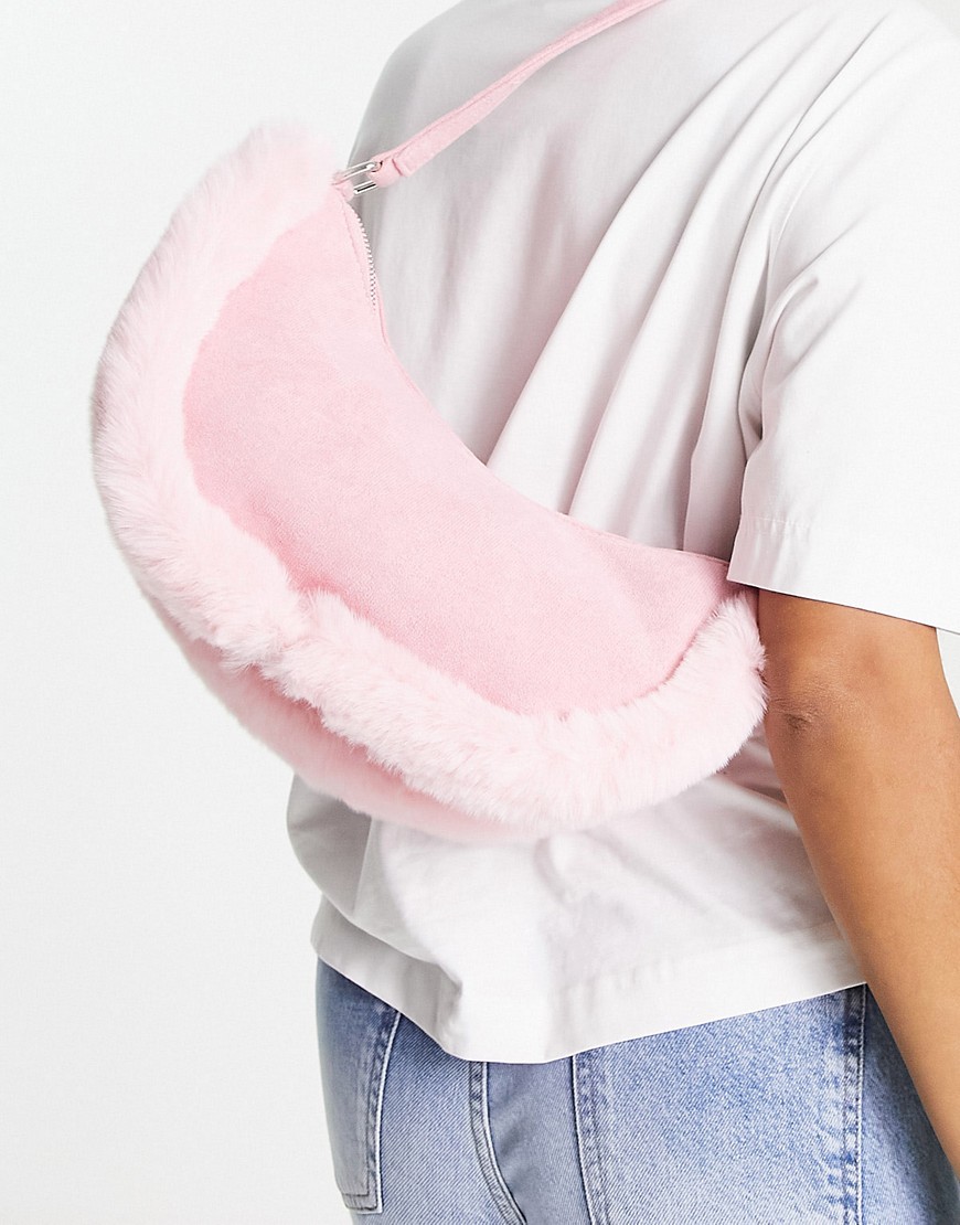 Public Desire The Kinley half moon bag in pink with faux fur trim