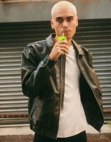 ASOS DESIGN oversized bomber jacket in distressed faux leather in green