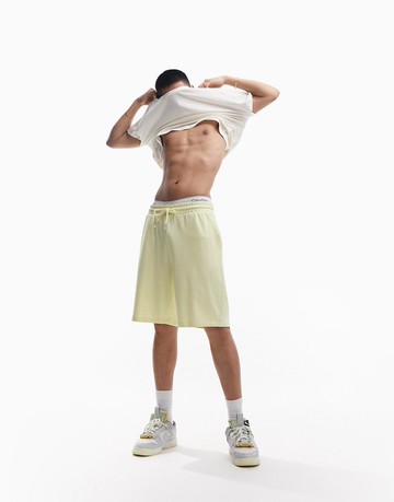 ASOS DESIGN oversized jersey mid length shorts in pastel yellow