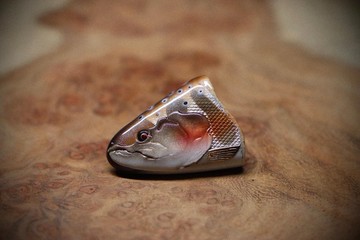 A handcrafted wooden brown trout brooch