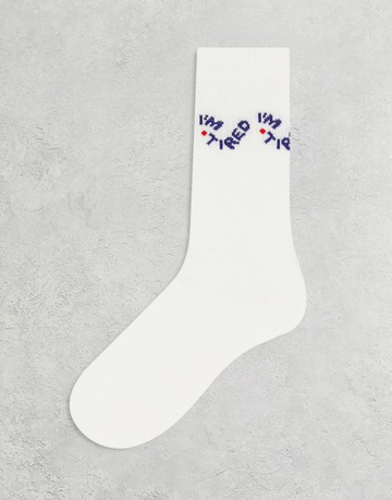 ASOS DESIGN im tired slogan socks in white