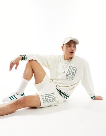 ASOS DESIGN co-ord oversized shorts in off white towelling with collegiate embroidery-Neutral