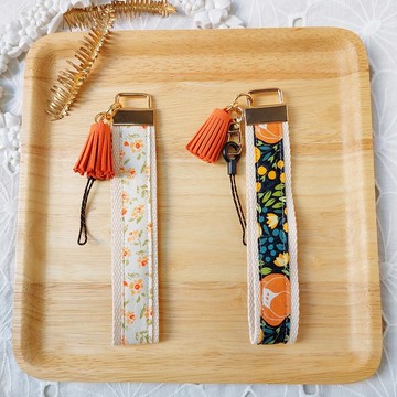 橘色系花布流蘇手機防摔手腕帶